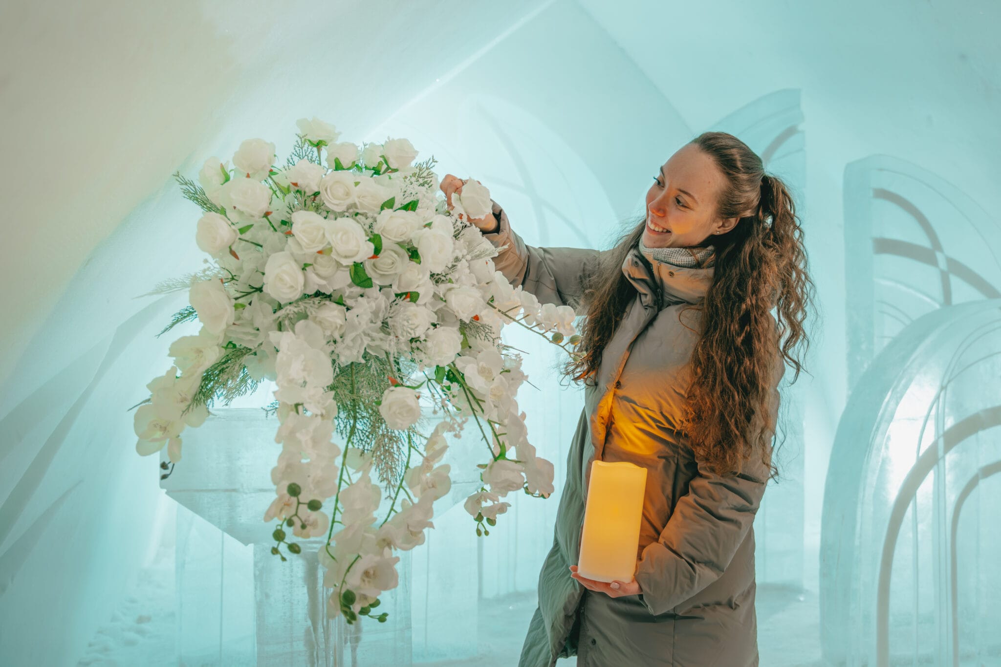 Our team setting up white florals and lanterns in the Ice Chapel at the Arctic SnowHotel before a winter wedding we styled.