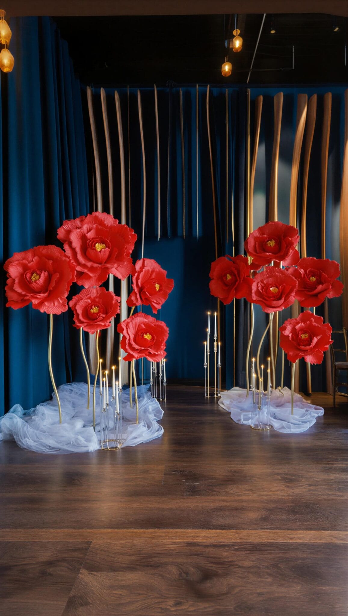 Red flowers and candles from our styling collection — the palette we reach for most often in December